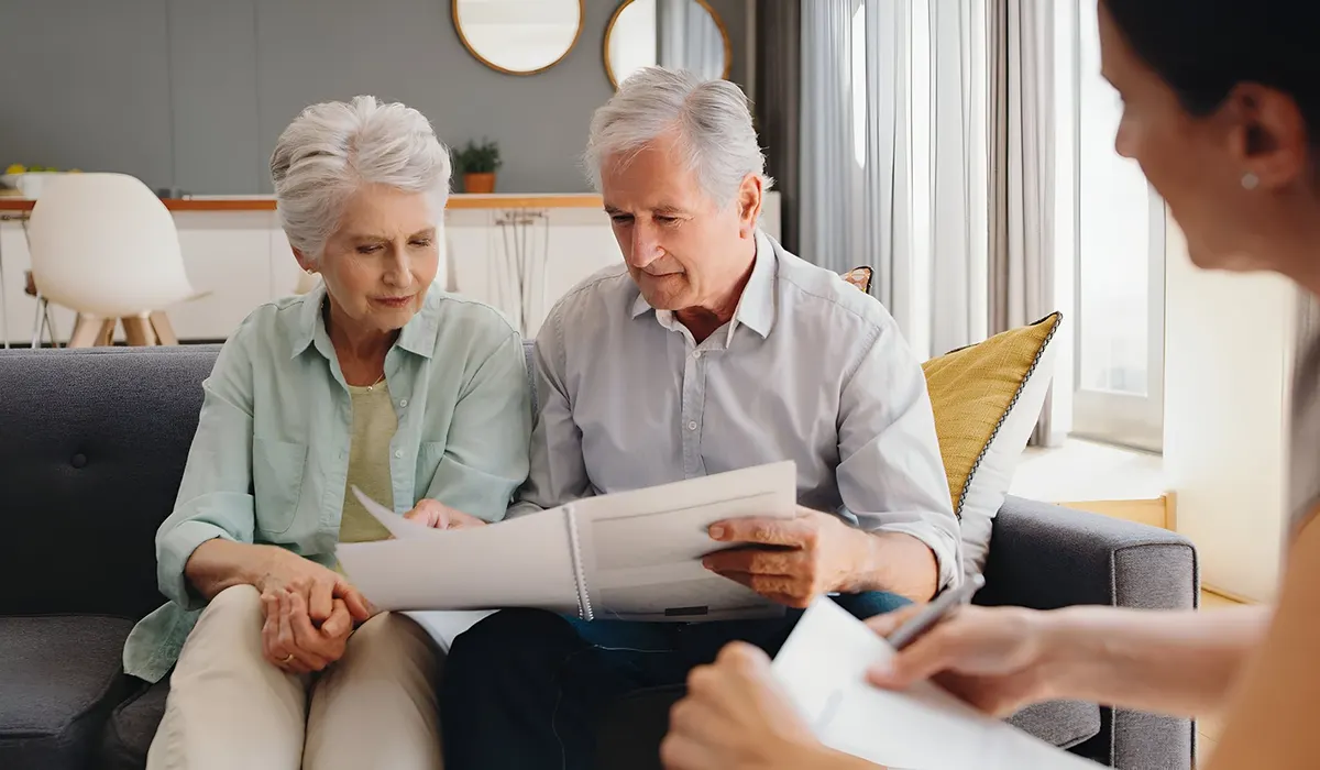 Senior couple reviewing estate documents with a lawyer